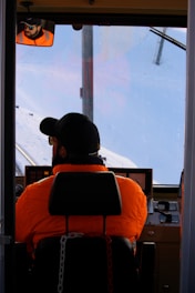 Operator inside a 360-degree tower cab with clear visibility in snowy conditions.