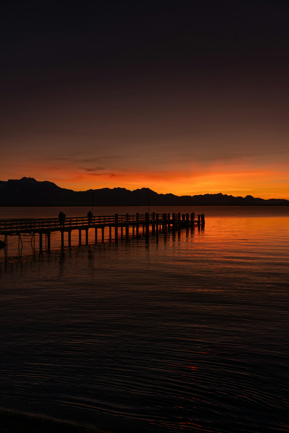 a boat is sitting on the water at sunset