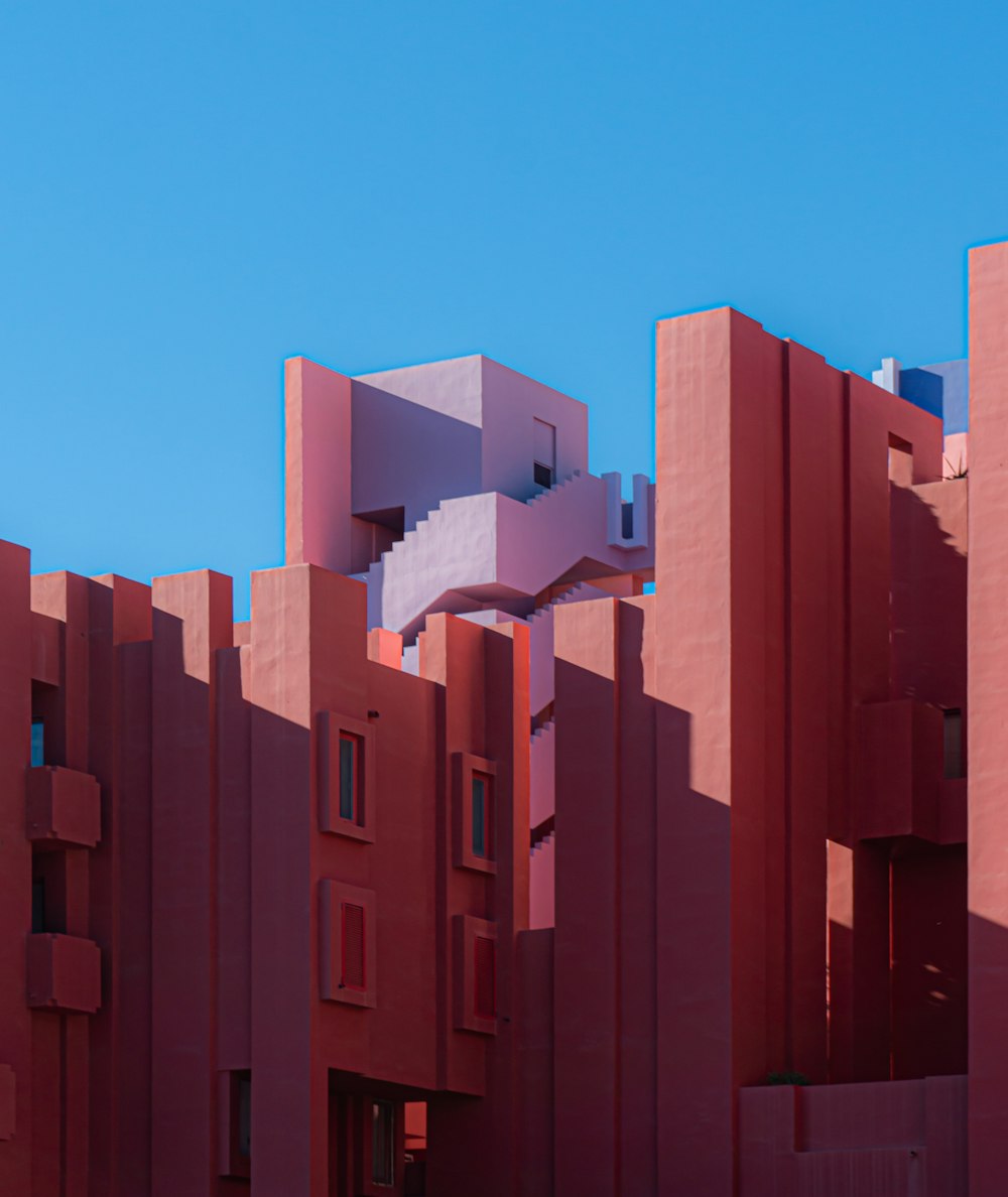 a red building with a staircase going up the side of it