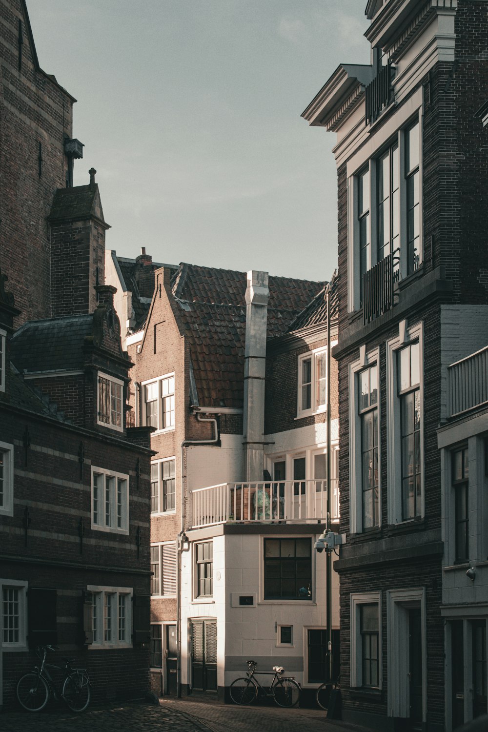 a row of buildings with bicycles parked in front of them