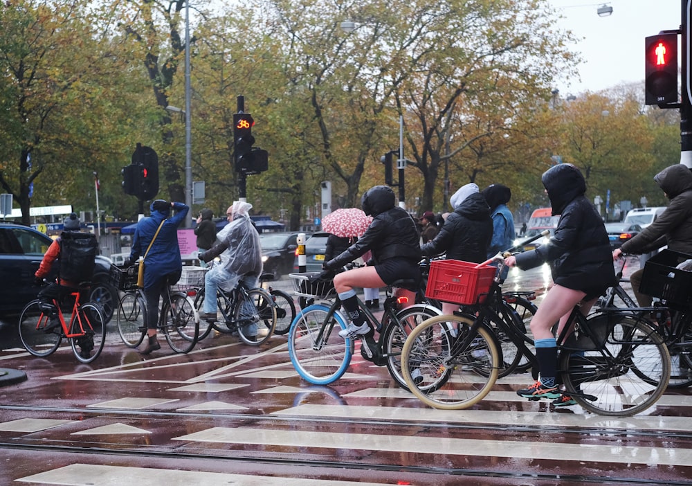 a group of people riding bikes down a street