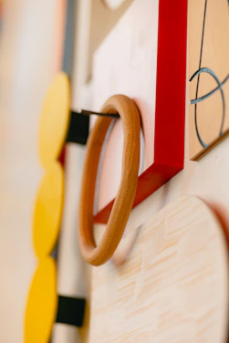 Close-up of a vibrant digital art print on a sleek metal plate attached to a modern wall with magnets.