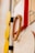 A close-up view of a modern, abstract wall design featuring geometric shapes. The composition includes wooden circles, a rectangular red frame, and a board with abstract linework. Earthy tones are prominent, contributing to a contemporary aesthetic.