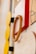 A close-up view of a modern, abstract wall design featuring geometric shapes. The composition includes wooden circles, a rectangular red frame, and a board with abstract linework. Earthy tones are prominent, contributing to a contemporary aesthetic.