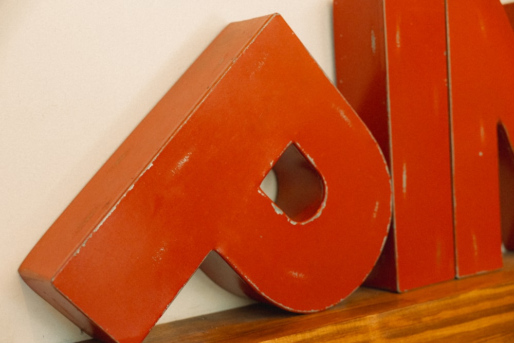 a close up of a wooden sign on a wall