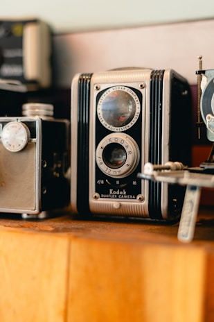 Close-up of professional photography equipment displayed on a wooden shelf.