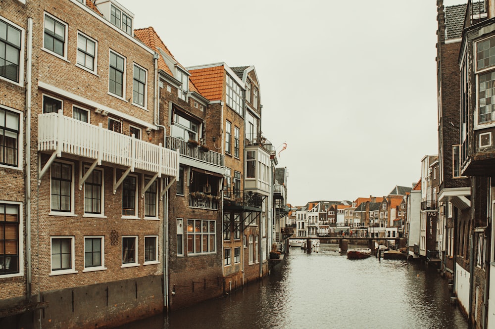 a river running through a city next to tall buildings