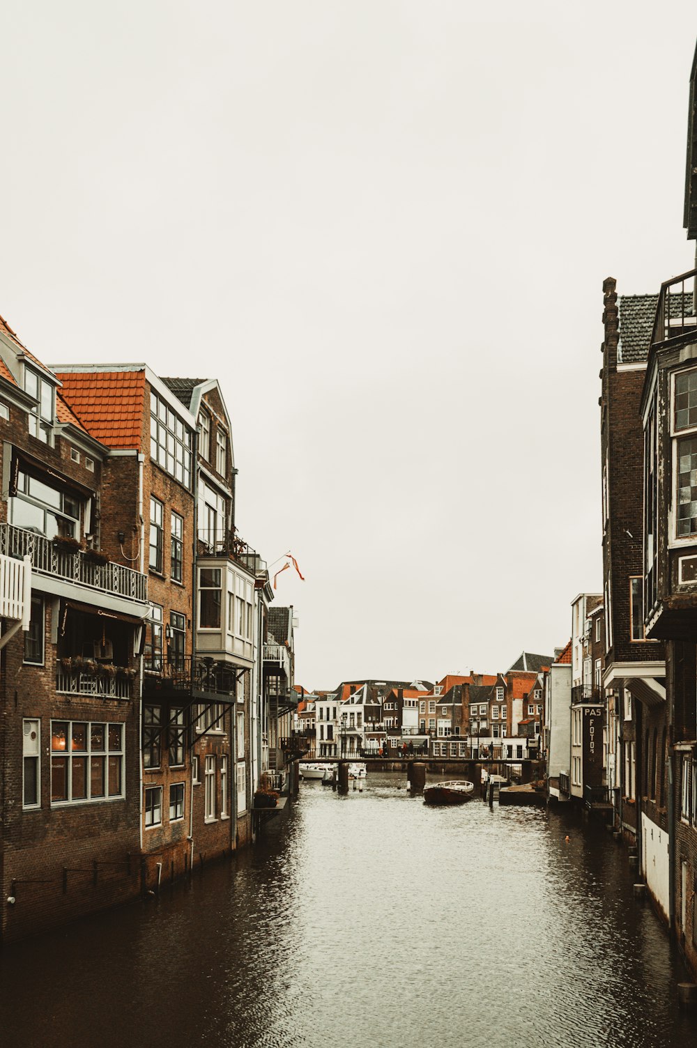 a river running through a city next to tall buildings