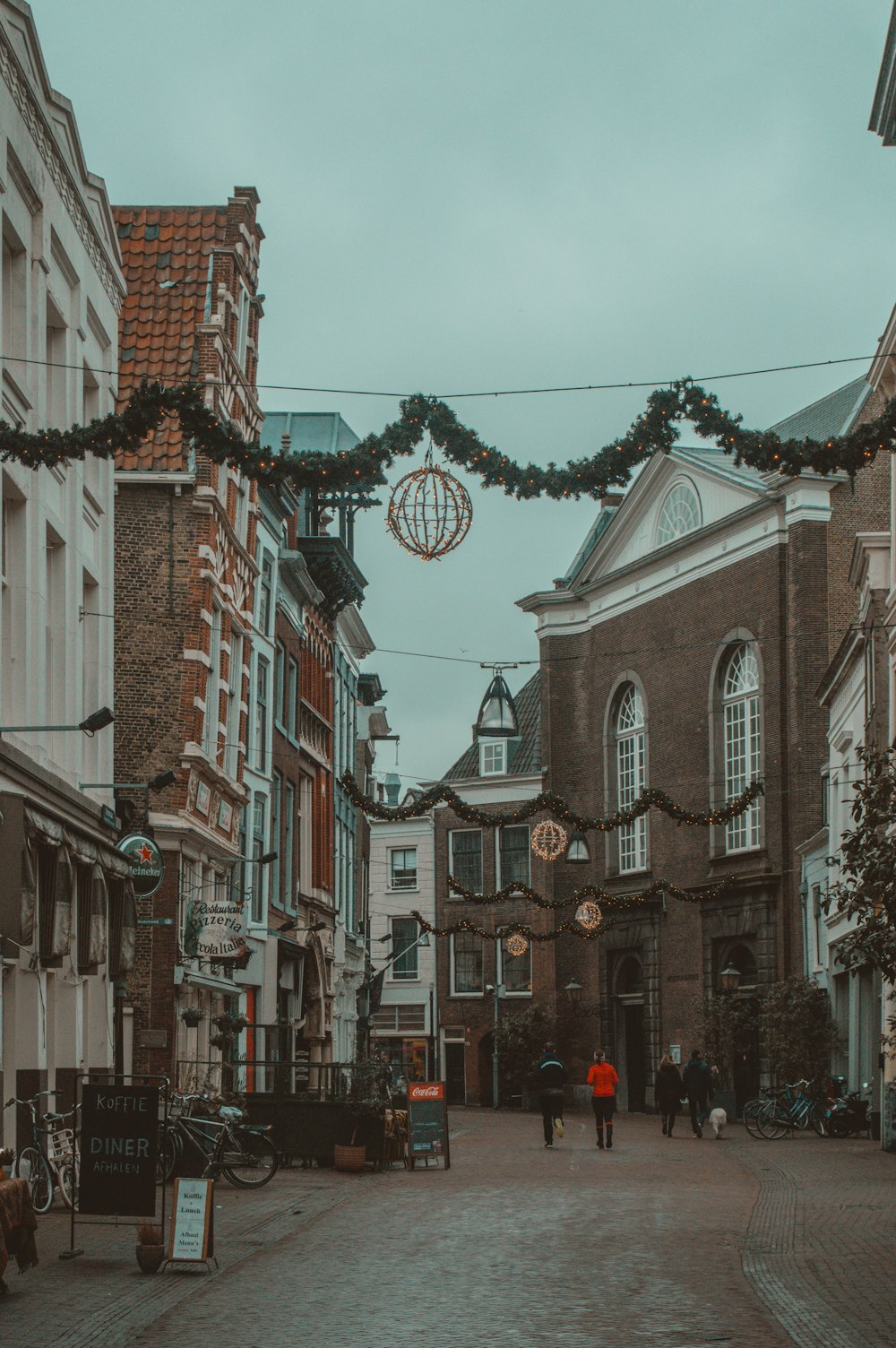 a couple of people that are walking down a street