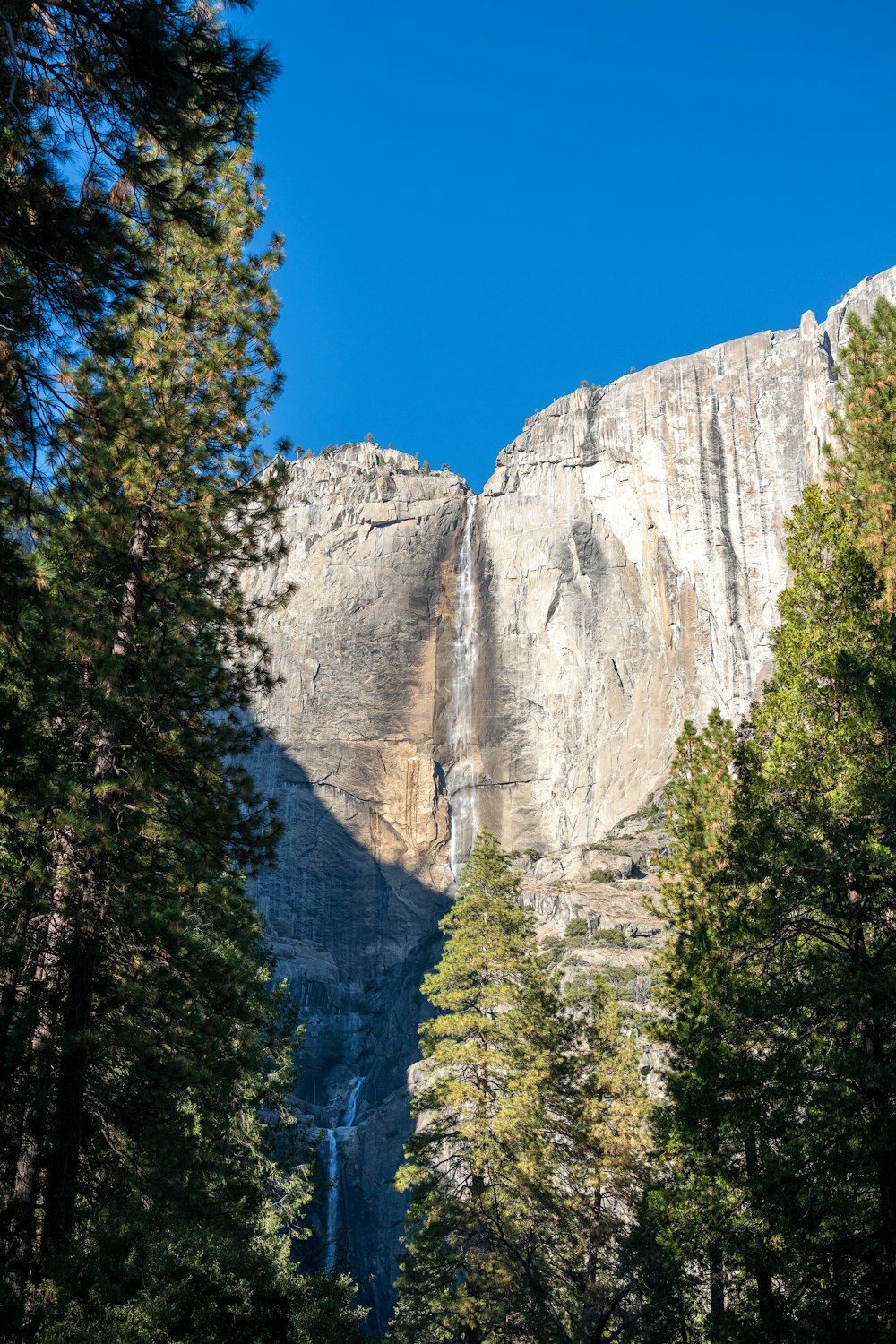 a view of a mountain with a waterfall in the distance