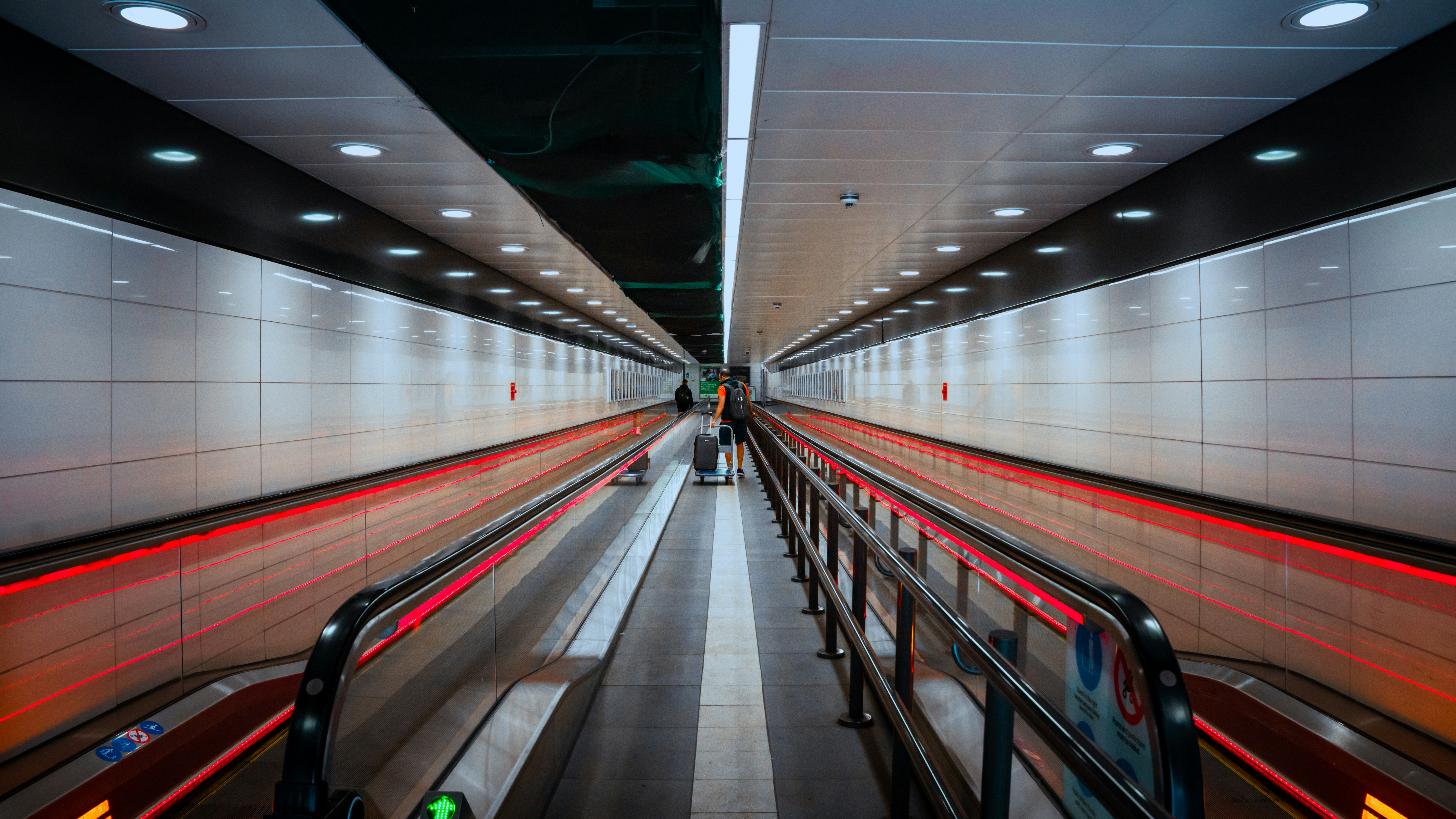 a subway station with a long line of escalators, 