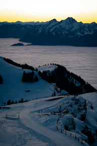 Snow-capped mountains of Gulmarg glowing softly at sunrise, inviting adventure seekers.