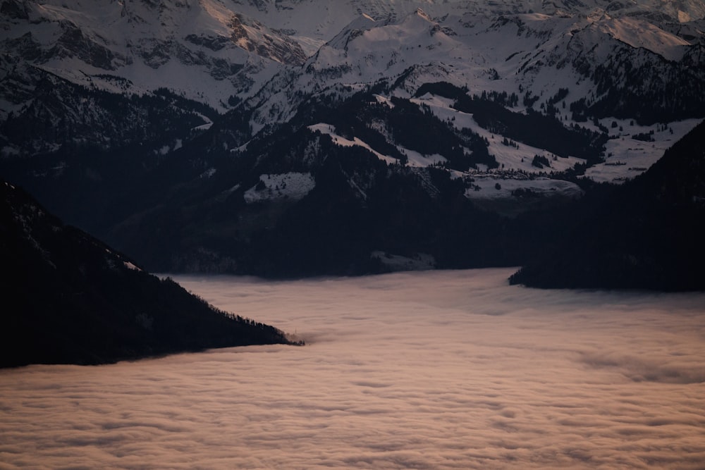 a view of a mountain range covered in clouds