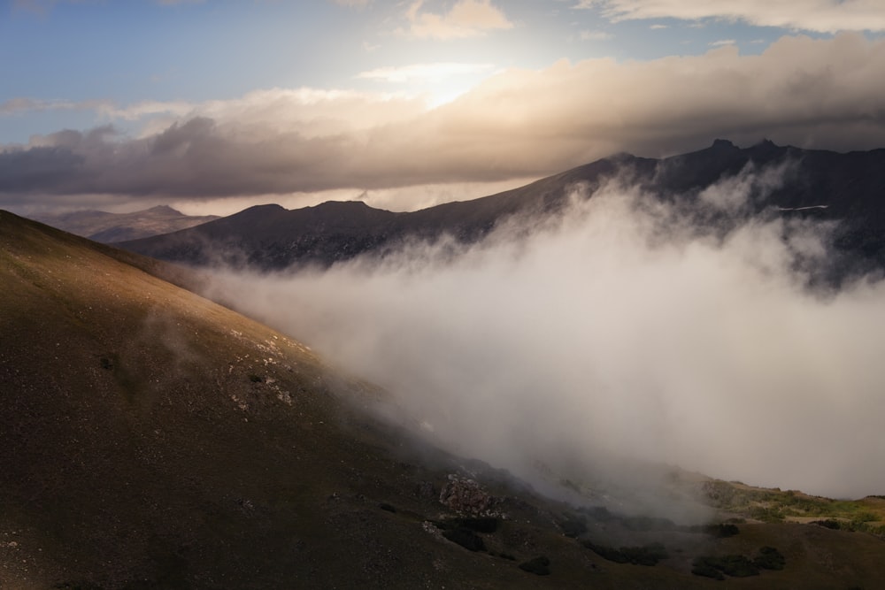 a view of a mountain covered in clouds