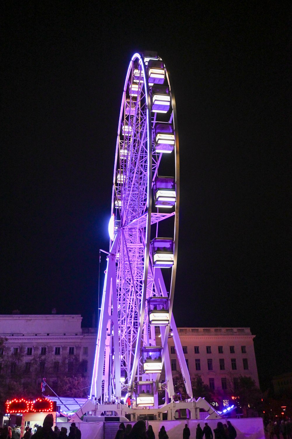 a ferris wheel is lit up at night