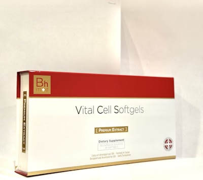 A box labeled 'Vital Cell Softgels' features a red and gold design. It is branded with 'Bh mod' and described as a dietary supplement containing 30 softgels of premium extract.