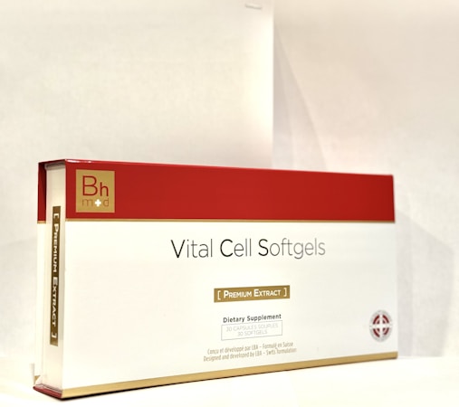 A box labeled 'Vital Cell Softgels' features a red and gold design. It is branded with 'Bh mod' and described as a dietary supplement containing 30 softgels of premium extract.