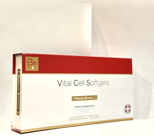 A box labeled 'Vital Cell Softgels' features a red and gold design. It is branded with 'Bh mod' and described as a dietary supplement containing 30 softgels of premium extract.