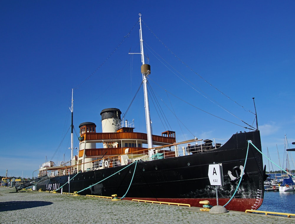 a large boat sitting on top of a sandy beach