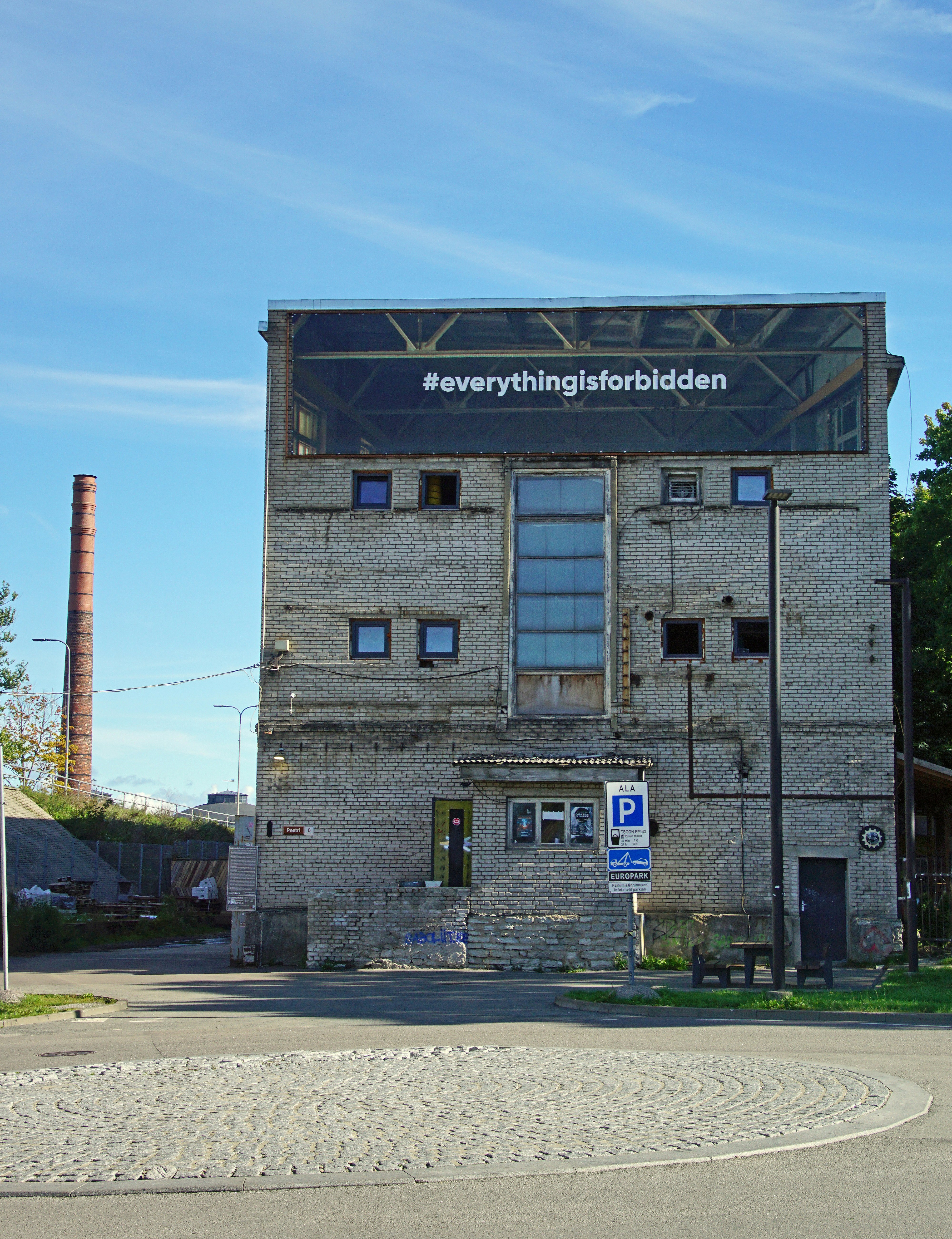 an old brick building with a sign on top of it