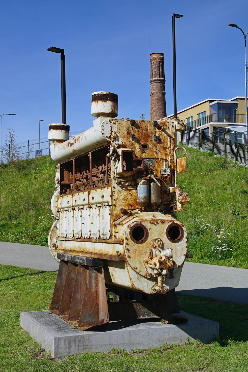 an old rusty train sitting on top of a cement block
