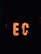 Large, illuminated letters spell out 'EC' in a dark environment, with numerous light bulbs embedded in them. A silhouette of a person stands to the right of the letters, partially visible against the bright lighting of the sign.