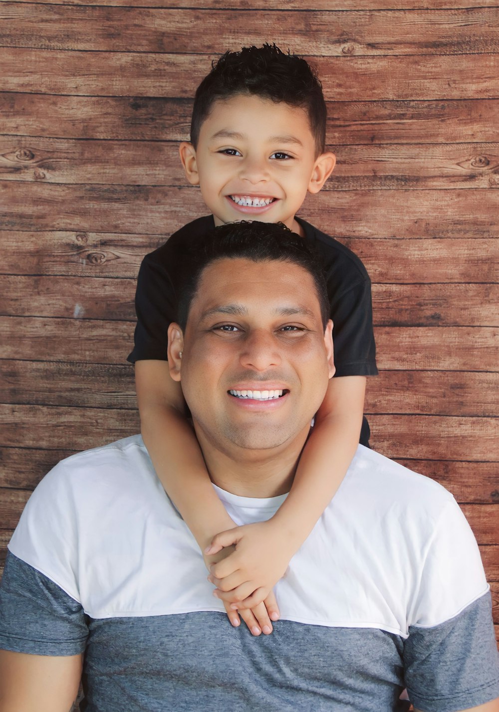 a man holding a young boy on his shoulders