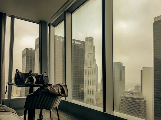 A cozy, modern apartment with a view of Sydney's skyline at sunset, welcoming business travelers.