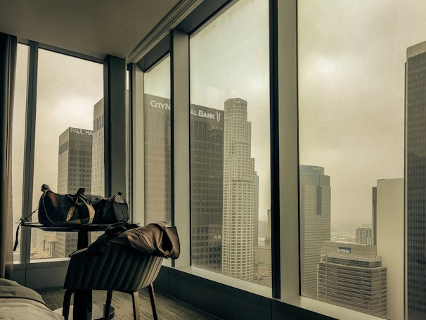 Stylish suite in New York City with a view of skyscrapers through the window.