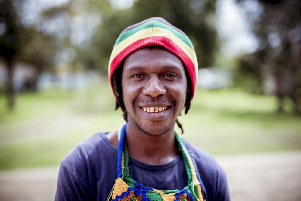 a man wearing a multicolored hat and apron