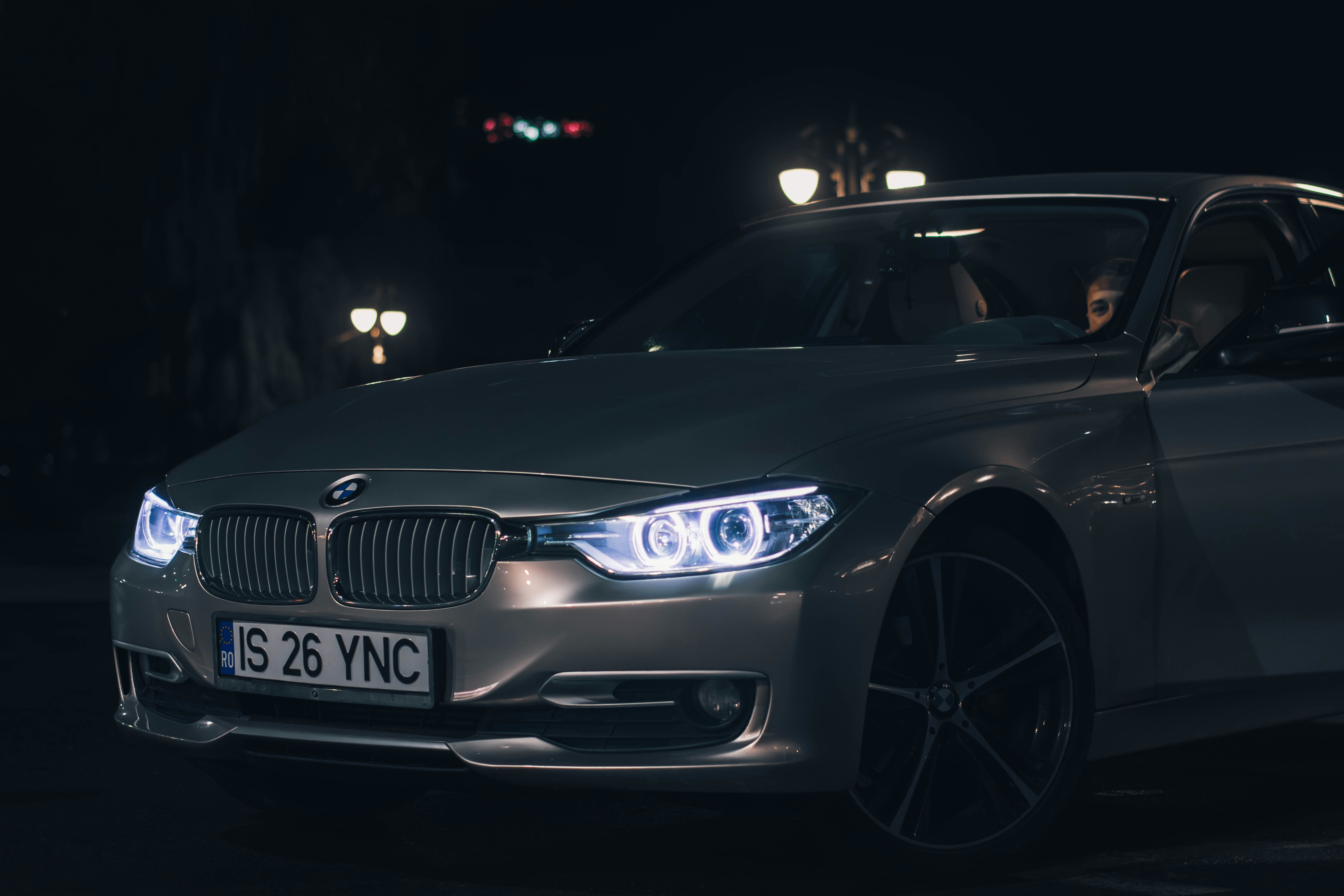 a silver car parked in a parking lot at night
