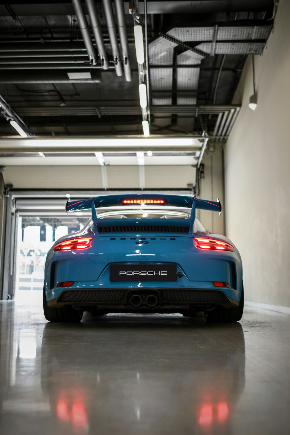a blue sports car parked in a garage
