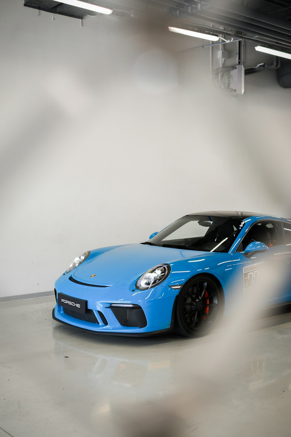 a blue sports car parked in a garage