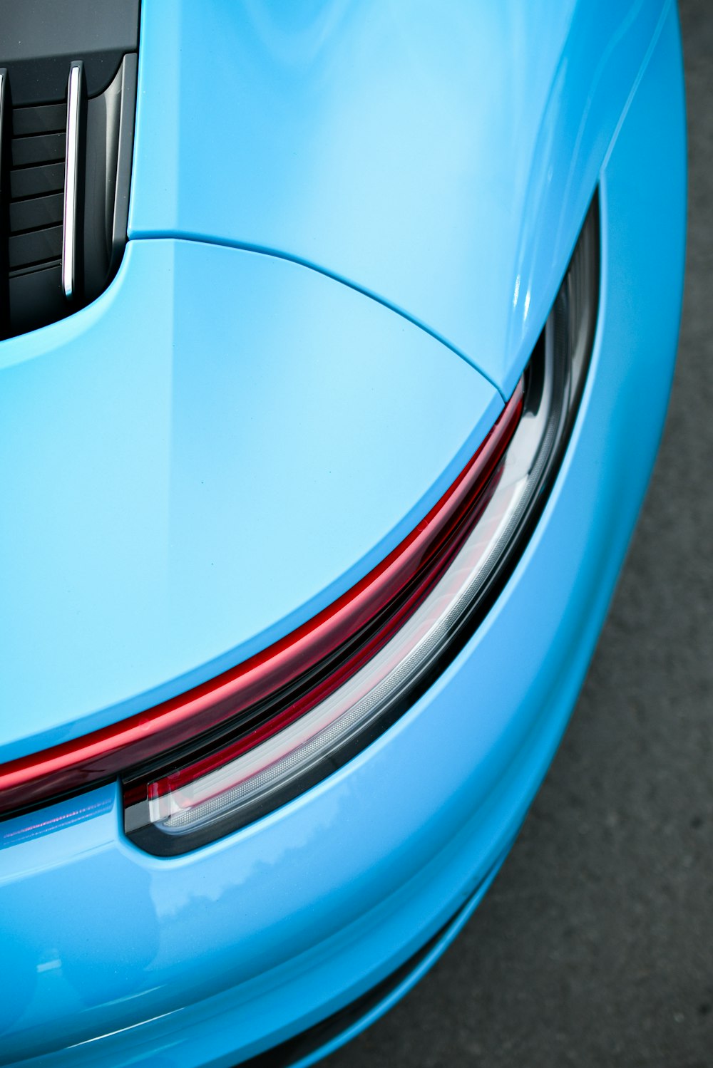 the tail lights of a blue sports car