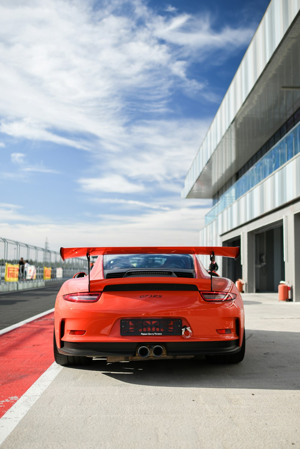 a red sports car parked in front of a building