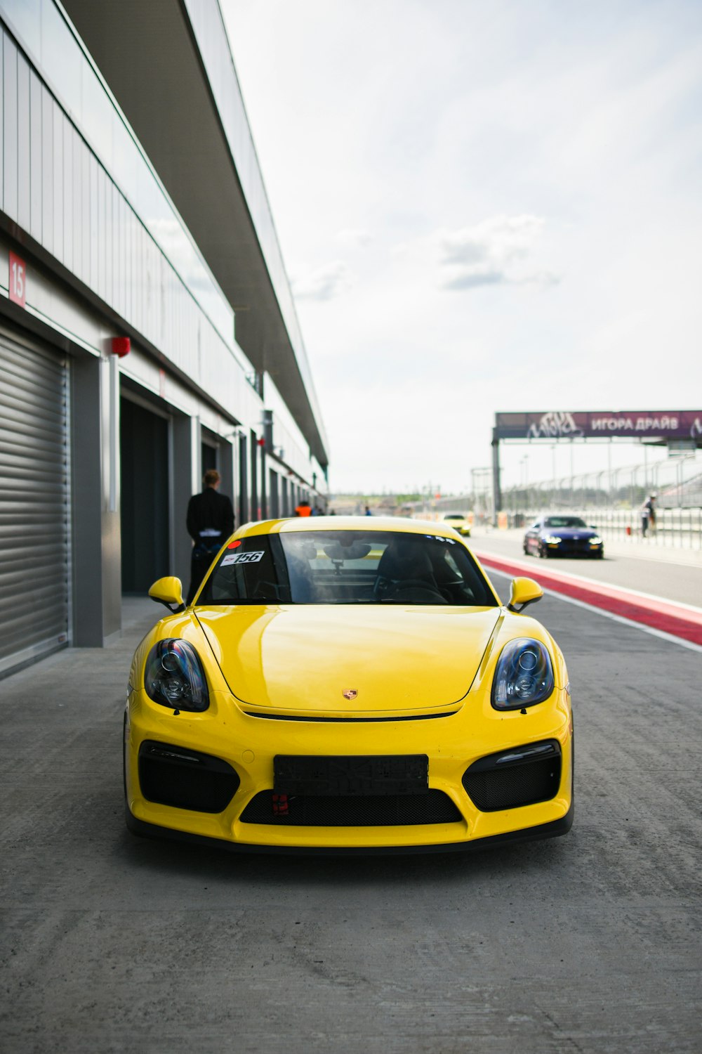 a yellow sports car parked in front of a building