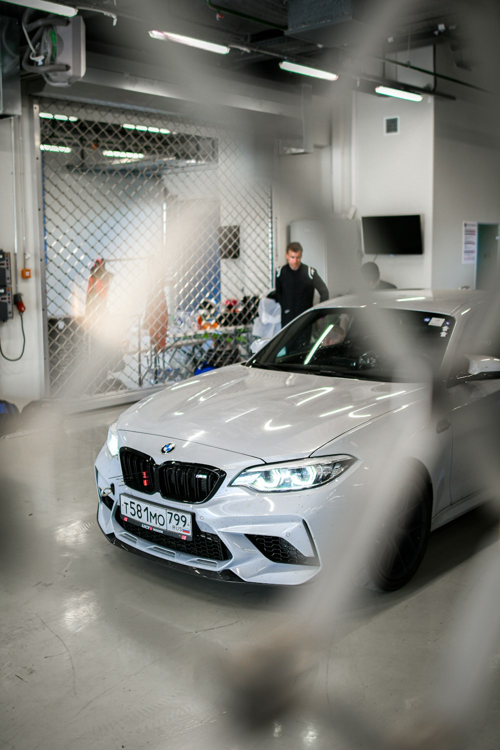 a white car is parked in a garage