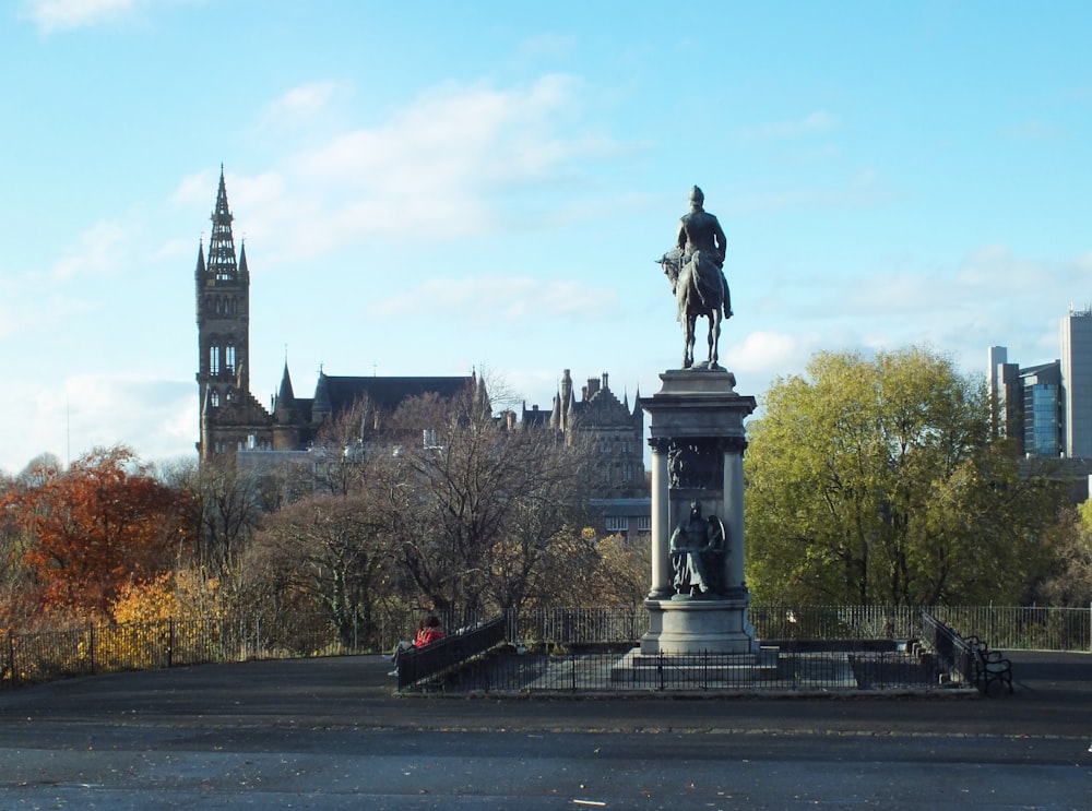 a statue of a man on a horse in a park