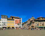 A vibrant city square bustling with people and colorful buildings