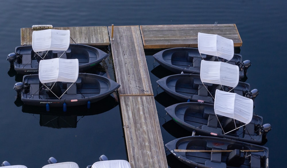 a group of small boats tied to a dock