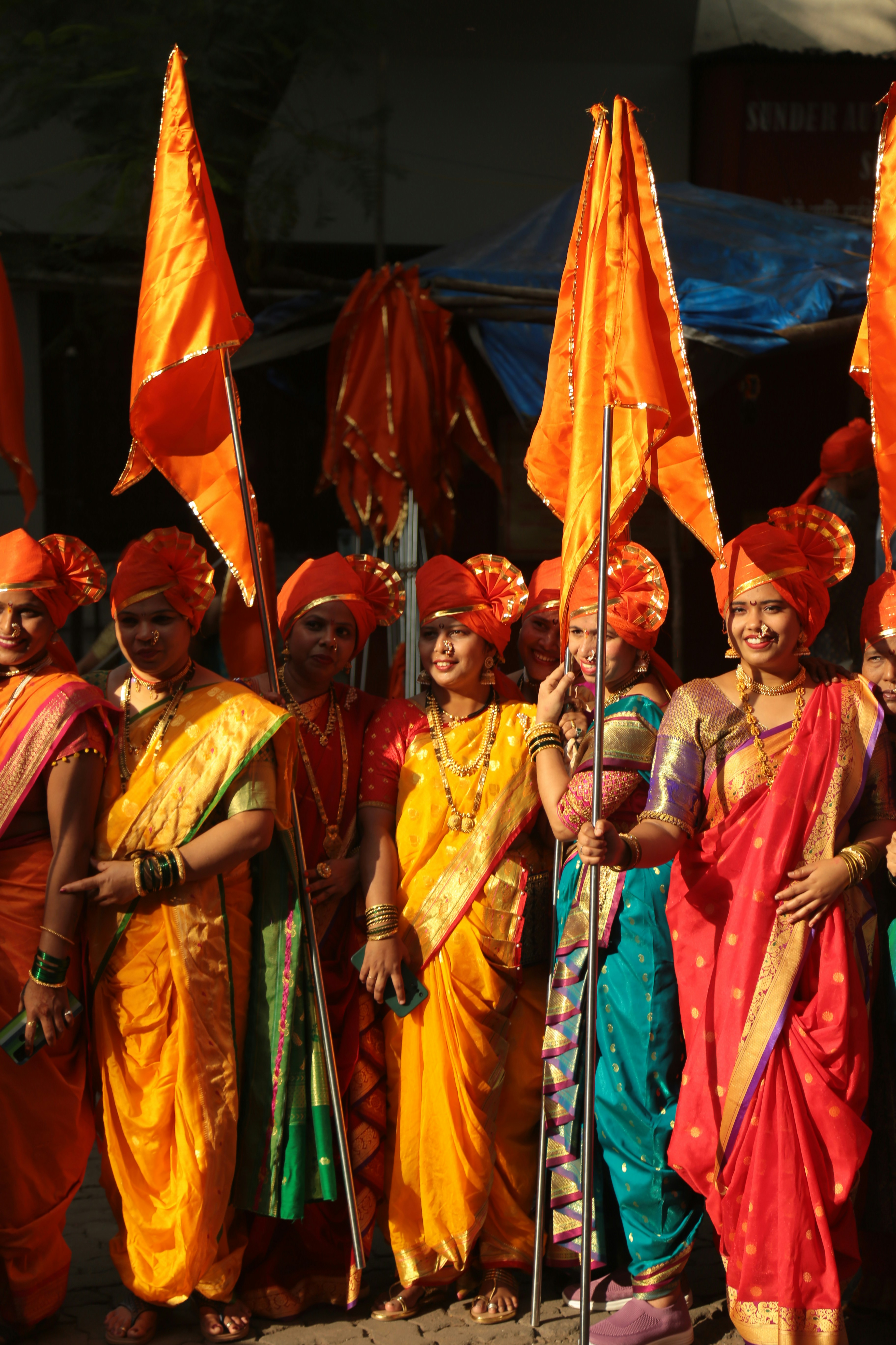 a group of people dressed in orange and yellow