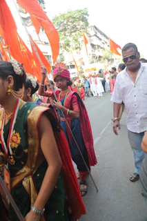 A vibrant gathering of Vijay Path Sena members during a cultural procession with traditional attire and flags.