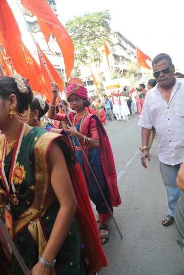 A vibrant gathering of Vijay Path Sena members during a cultural procession with traditional attire and flags.