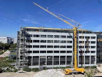 Close-up of workers coordinating near a crane on a clean, modern construction site.
