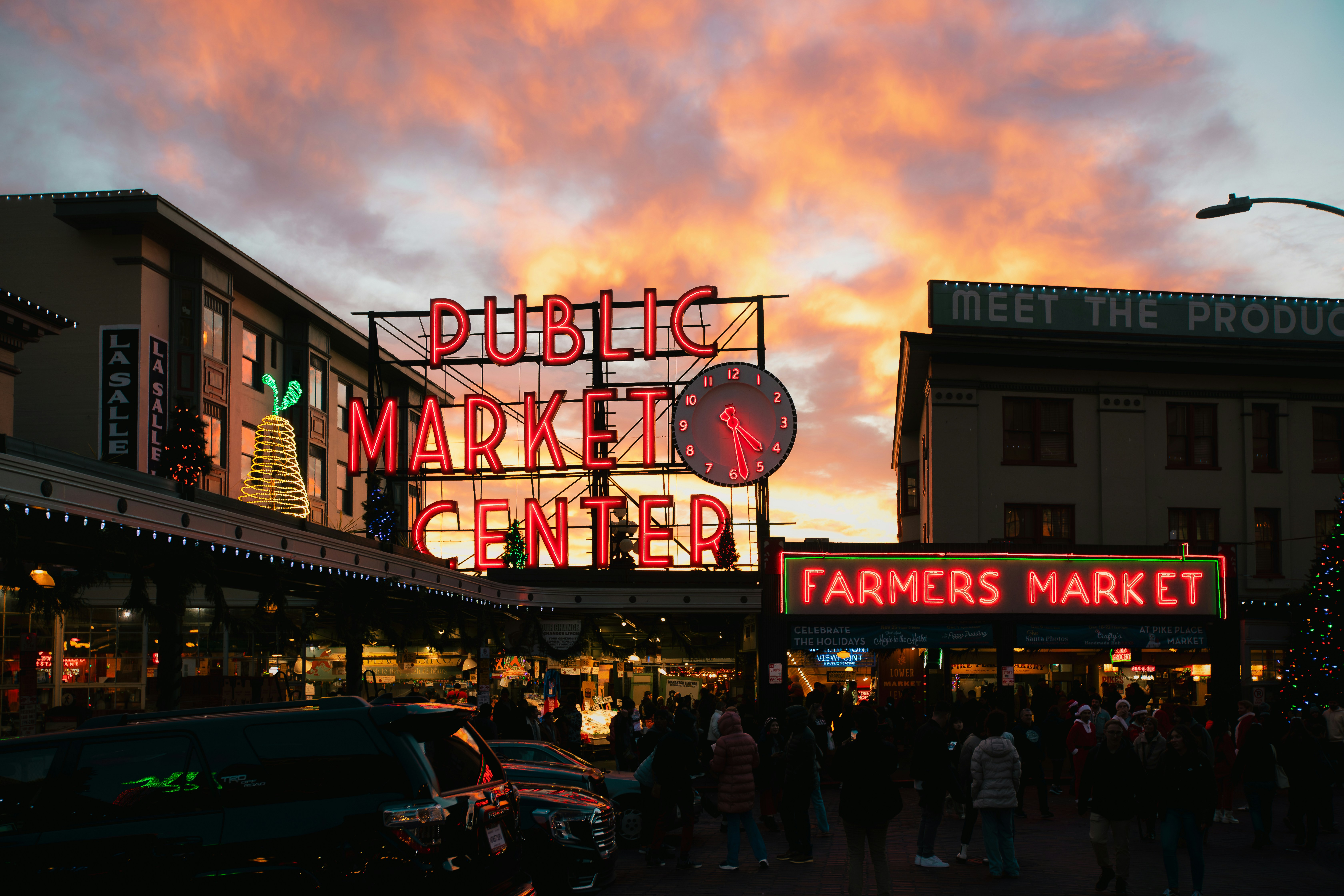 a group of people standing outside of a market