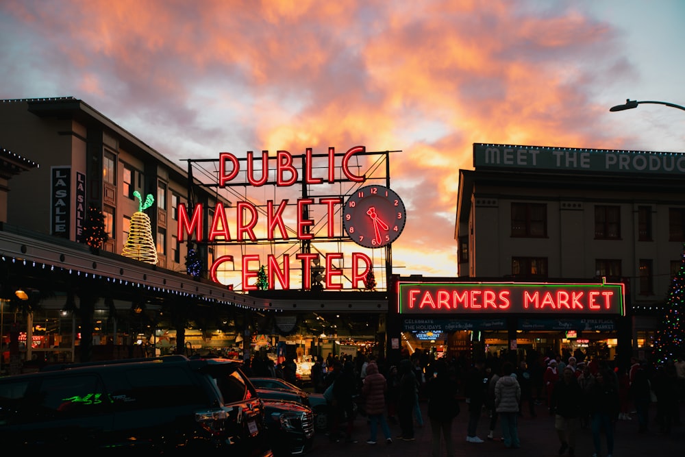 a group of people standing outside of a market