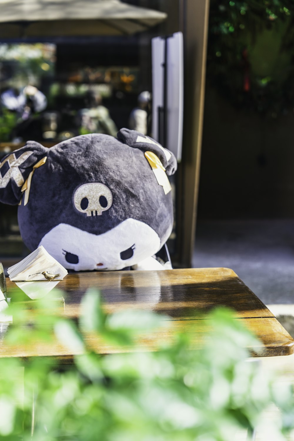 a stuffed animal sitting on top of a wooden table