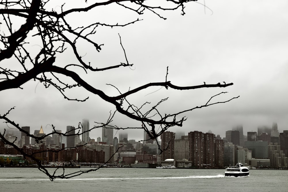 a boat in the water with a city in the background