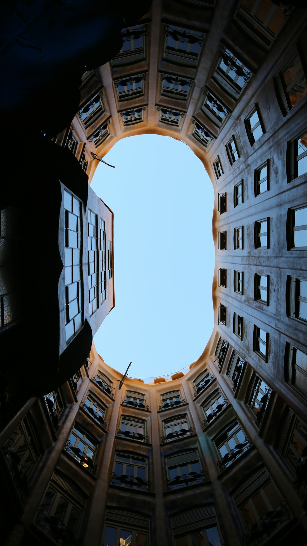 looking up at a circular window in a building