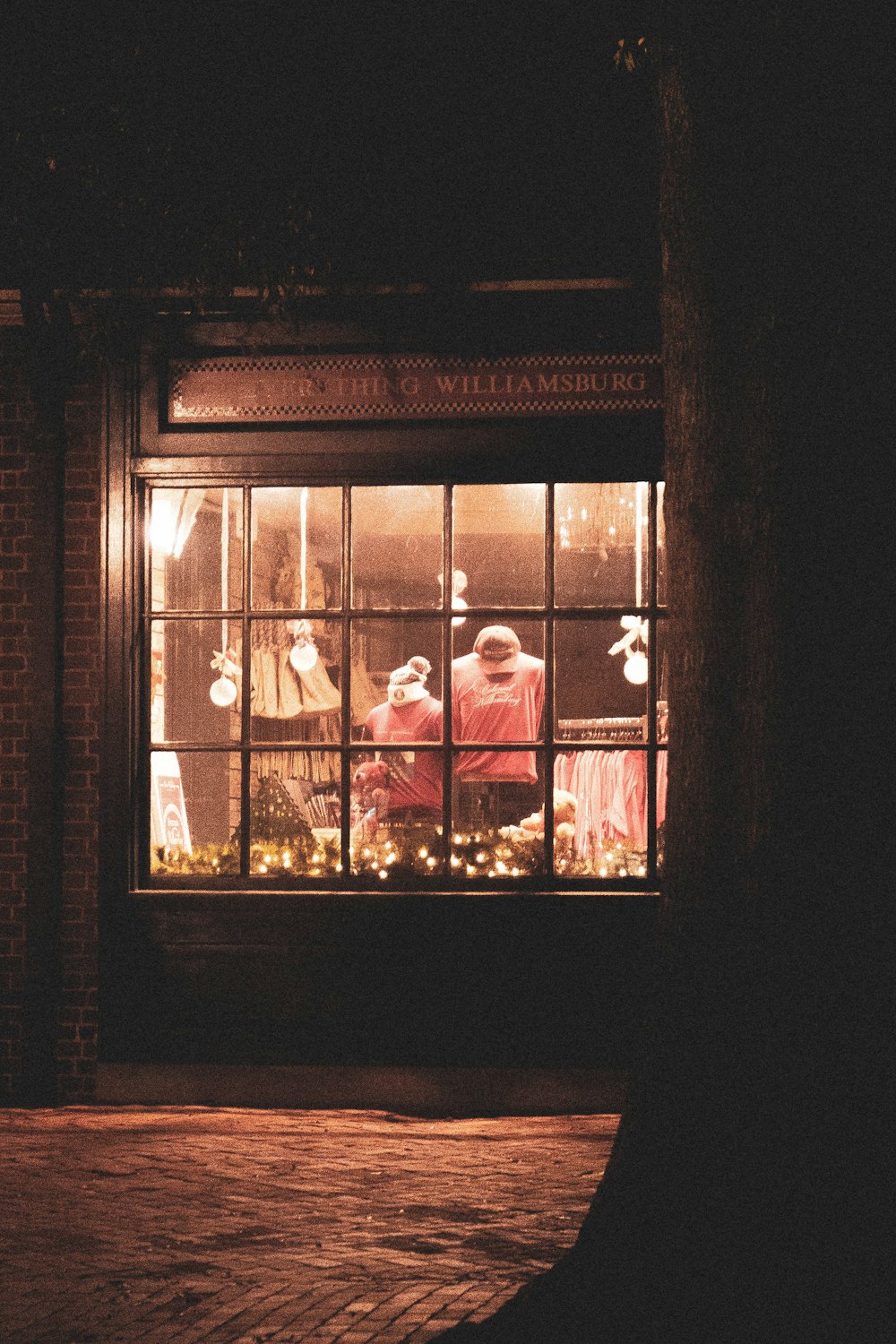 a group of people sitting in a window at night